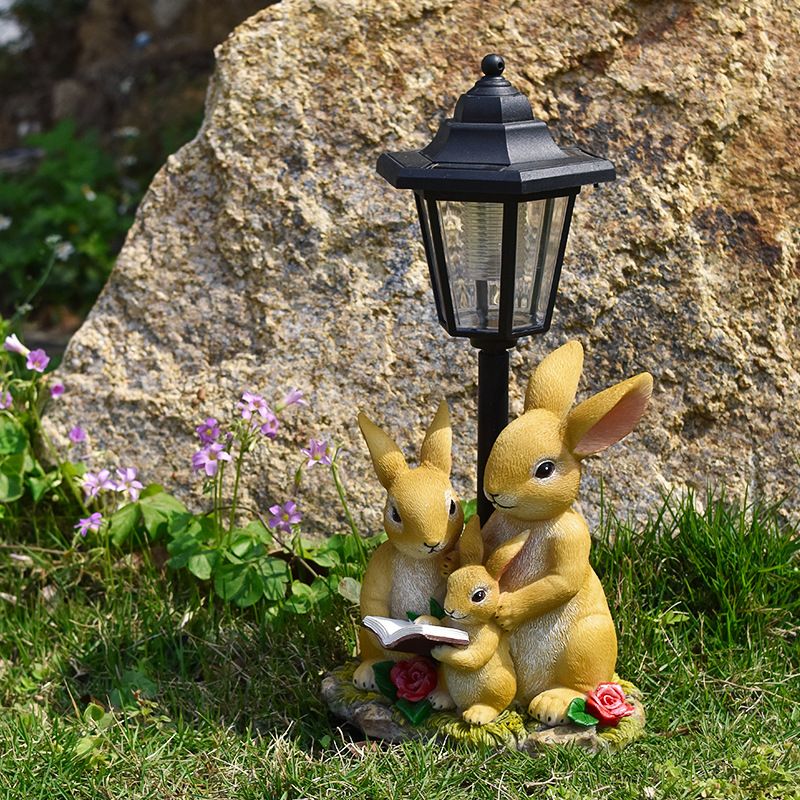Solar Simulation Rabbit Ornament, charges by day and lights up automatically at night, three rabbits cluster around a street lamp with 