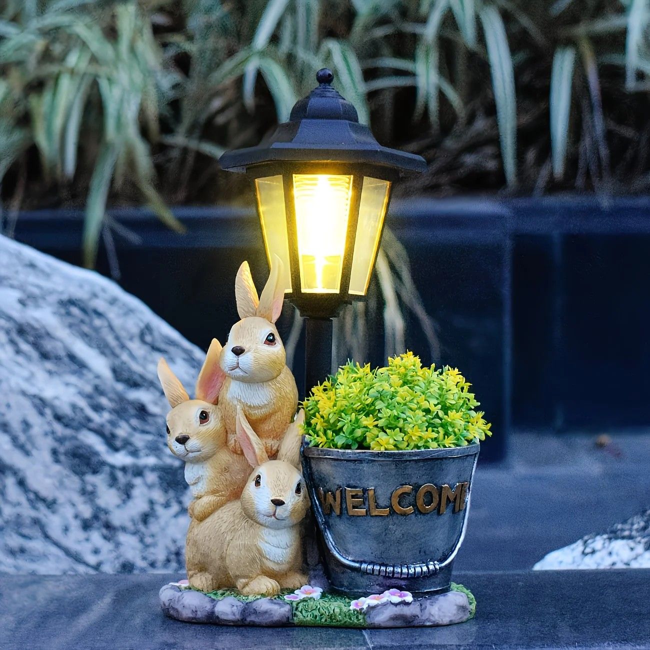 Solar Simulation Rabbit Ornament, charges by day and lights up automatically at night, three rabbits cluster around a street lamp with 