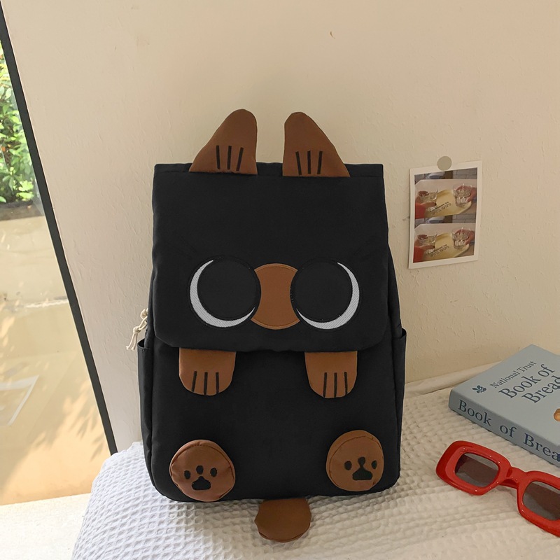 Black Lightweight Nylon Waterproof Schoolbag for Children - Large Capacity Daypack with Ugly-Cute Cat Design - Image 1