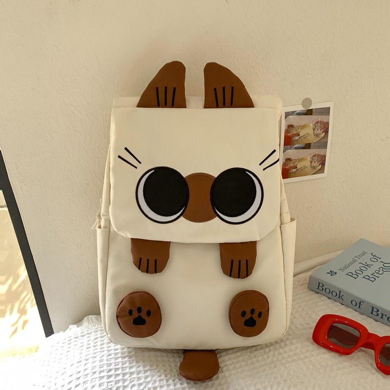 White Lightweight Nylon Waterproof Schoolbag for Children - Large Capacity Daypack with Ugly-Cute Cat Design - Image 1