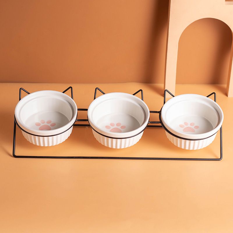Triple Slanted Ceramic Pet Bowl Set with Elevated Iron Stand and Non Slip Base - 3 x 300ML Versatile Pink Cat Paw Print Pattern Dishes for Water & Food - Image 1