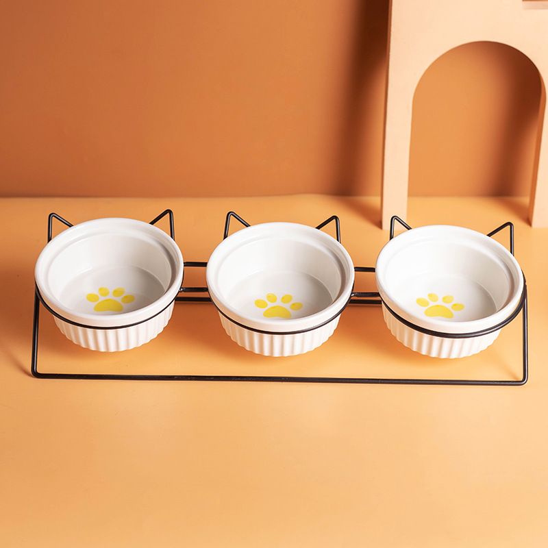 Triple Slanted Ceramic Pet Bowl Set with Elevated Iron Stand and Non Slip Base - 3 x 300ML Versatile Yellow Cat Paw Print Pattern Dishes for Water & Food - Image 1